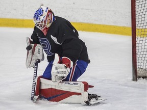 Kevin Poulin of the Laval Rocket stops a shot at practice at Place Bell in Laval on Thursday, April 21, 2022.