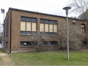 Windows are boarded up following a fire last week at the Cedar Park Heights chalet in Pointe-Claire.