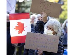 People gather in N.D.G. Park to protest against Bill 96 in Montreal, on Sunday, Oct. 24, 2021.