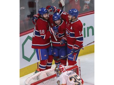 Mike Hoffman (left) is congratulated by Canadiens teammates Nick Suzuki (right) and Cole Caufield (centre)at the Bell Centre in Montreal on Friday, April 29, 2022.