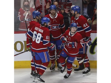 Canadiens' Cole Caufield (centre) is congratulated by teammates, clockwise from the left, Mike Hoffman, Nick Suzuki, Jeff Petry and Joel Edmundson after scoring his first goal of the night against the Florida Panthers at the Bell Centre in Montreal on Friday, April 29, 2022.