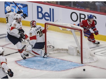 Canadiens' Cole Caufield skates around the net after scoring a goal against goalie Jonas Johansson against the Florida Panthers at the Bell Centre in Montreal on Friday, April 29, 2022. Defending is Lucas Carlsson.