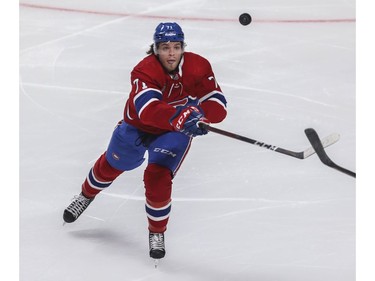 Canadiens' Jake Evans tries to control a puck in a game against the Florida Panthers at the Bell Centre in Montreal on Friday, April 29, 2022.