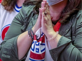 A Habs fan appears to be seeking divine intervention during the Stanley Cup finals last June. "Hockey was like a religion and my parents knew they had to understand it and recite its prayers," Martine St-Victor writes.