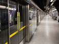 Platform screen doors are visible at Westminster underground station in London. A project to install similar safety equipment at 13 Montreal métro stations has been shelved due to budget cuts prompted by the pandemic.