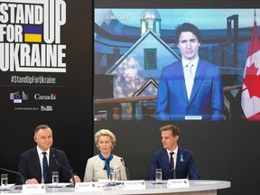 (L-R) Polish President Andrzej Duda, Ursula von der Leyen, President of the European Commission and CEO of Global Citizen Hugh Evans attend the event "Stand up for Ukraine" joined by Prime Minister Justin Trudeau via video link in Warsaw, Poland on April 9, 2022.