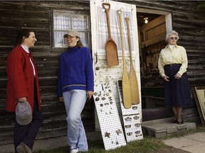 Susie Aird left, Mary Aird, and Barbara Aird finish up a busy Saturday at Finnegan's open air flea, craft and antique market in Hudson in 2004.