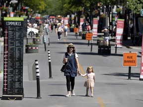 Moire Stevenson and her daughter, Elodie, stroll down the newly created pedestrian mall on Wellington St. in Verdun in 2020.