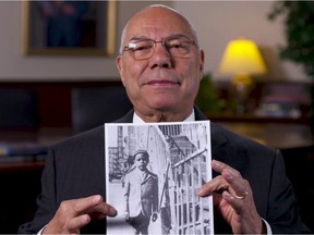 Colin Powell holds a photo of himself at the Automat circa 1943.