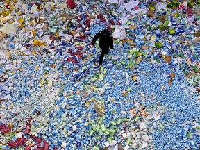 In this photo from 2013, a Chinese policeman walks across a pile of fake medicines seized in Beijing, which were later destroyed. The marketing of counterfeit drugs has blossomed into a global industry that leaves a swath of misery in its wake, writes Joe Schwarcz.