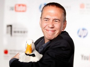 Comedian Gilbert Gottfried arrives with a duck at the Webby Awards in New York City, June 14, 2010.