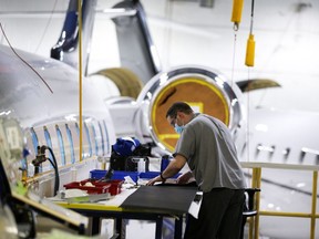 A Bombardier employee works on a Global aircraft at the Laurent Beaudoin Completion Centre in Dorval on March 29, 2022.