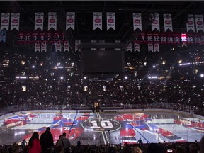 Images of hockey legend Guy Lafleur are projected on the ice during a ceremony at the Bell Centre prior to an NHL hockey game between the Montreal Canadiens and Boston Bruins in Montreal, Sunday, April 24, 2022. Lafleur passed away on April 22 at the age of 70.