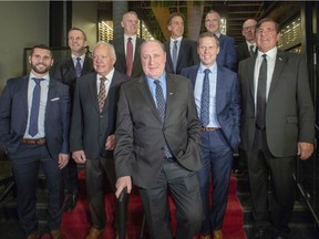 Former captains of the Montreal Canadiens pose for pre-game photos on the 110th anniversary of the team's founding in Montreal, on Dec. 3, 2019. Front row, from left: Brian Gionta, Yvan Cournoyer, Bob Gainey, Saku Koivu and Serge Savard. Back row, from left: Guy Carbonneau, Vincent Damphousse, Chris Chelios, Pierre Turgeon and Mike Keane.
