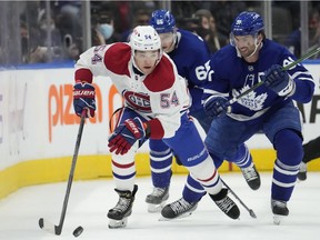Canadiens defenceman Jordan Harris (54) carries the puck up ice as Toronto Maple Leafs centre John Tavares (91) defends in Toronto on Saturday, April 9, 2022.