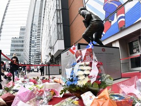 Flowers and objects at the base of the statue of Guy Lafleur before the game between the Boston Bruins and the Montreal Canadiens at the Bell Centre on April 24, 2022.