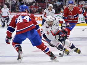 Washington Capitals forward Alex Ovechkin (8) plays the puck against Canadiens defenceman Joel Edmundson (44) during the third period at the Bell Centre on Saturday, April 17, 2022, in Montreal.