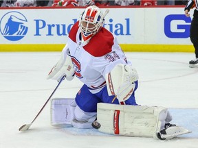 Canadiens goaltender Jake Allen makes a save against the New Jersey Devils during the second period at Prudential Center in Newark on April 7, 2022.