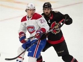Montreal Canadiens left wing Christian Dvorak (28) battles with Ottawa Senators center Mark Kastelic (47) in the third period at the Canadian Tire Centre on April 23, 2022.