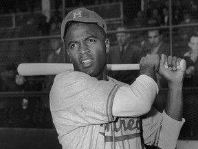 American baseball player Jackie Robinson holding a bat in his Montreal Royals uniform, the Brooklyn Dodgers farm team, circa 1946.