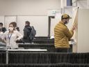 A voter enters the voting booth to vote in the first round of the 2022 French presidential election in Montreal on Saturday, April 9, 2022.