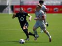 CF Montreal midfielder Samuel Piette controls the ball in front of Toronto FC forward Jacob Shaffelburg during the second half at DRV PNK Stadium on April 17, 2021 in Fort Lauderdale, Florida.