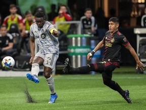 CF Montréal midfielder Victor Wanyama passes in front of Atlanta United defender Alan Franco during the first half at Mercedes-Benz Stadium in Atlanta on March 19, 2022.