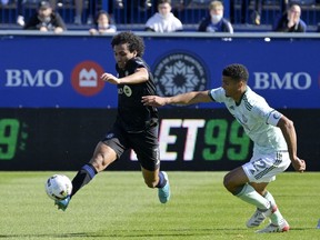 CF Montréal midfielder Ahmed Hamdi (7) plays the ball and Atlanta United FC defender Miles Robinson (12) defends during the first half at Saputo Stadium in Montreal on Saturday, April 30, 2022.