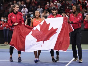 Canada's Rebecca Marino, from left to right, Leylah Annie Fernandez of Laval, captain Heidi El Tabakh and Francoise Abanda celebrate after Fernandez defeated Latvia's Daniela Vismane during a Billie Jean King Cup qualifier singles tennis match, in Vancouver on Saturday, April 16, 2022.