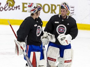 Canadiens' Jake Allen, right, chats with fellow netminder Sam Montembeault, during a practice at the Bell Sports Complex in Brossard on Jan. 10, 2022.