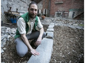Jean-Philippe Riopel, next to a foundation wall located inside the courtyard of his apartment in Chinatown.
