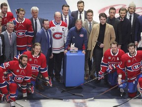 Longtime Canadiens equipment manager Pierre Gervais (centre with blue windbreaker) is honoured by the team before the last game of the season against the Panthers at the Bell Centre on April 29, 2022.
