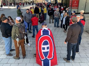 Canadiens fans wait outside the Bell Centre on May 1, 2022, to pay tribute to Guy Lafleur