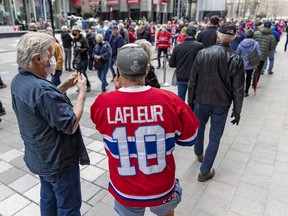 Hockey fans line up for the Guy Lafleur public visitation at the Bell Centre on Monday.