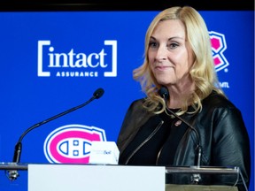 Chantal Machabée stands behind a podium with a Canadiens logo on it