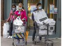 People wear masks as they exit a downtown shopping mall in Montreal on Wednesday, May 4, 2022. Public health officials announced the end of the mask mandate in most situations as of Saturday, May 14.
