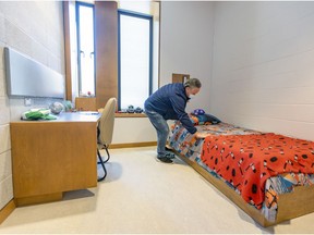 Franco Barillaro, a housekeeping manager for the West Island health agency, smooths covers on a resident's bed in a room in the new Batshaw Youth and Family Services campus in Beaconsfield last Friday.