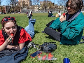 “This is my first summer here and I’m really happy that winter is over," said Clelia Aubigny, left, at Montreal's Jeanne-Mance Park on Friday. Manon Morin was less enthusiastic about the rise in temperature.