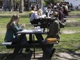 People enjoy their lunch on the picnic tables on the lawn of McGill University on Monday May 9, 2022. "Perhaps most heartwarming is the sense that people are not too busy to pay attention to one another," Julie Dreyer Wang writes.