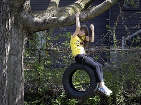 Nine-year-old Sofiia Ladnitska plays on a homemade swing in the yard of Tatiana Romano's home, where she and her family are staying after fleeing Ukraine. Romano says Sofiia received a warm welcome at the school she recently started to attend.