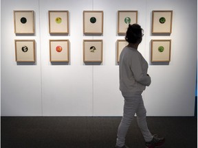 A woman looks at needlepoint by Carrie Allison at the Land Back contemporary native art exhibit at Stewart Hall in Pointe-Claire, which is one of the eight venues of the sixth edition of the Contemporary Native Art Biennial. The exhibition runs until June 19.