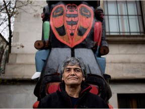 Charles Joseph stands with his Residential School Totem Pole outside the Montreal Museum of Fine Arts in May 2017.