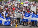 Protesters walk down Atwater Avenue during a rally to oppose Bill 96 in Montreal on Saturday, May 14, 2022. 