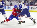 Syracuse Crunch's Fredrik Claesson blocks the path of Laval Rocket's Brandon Gignac towards the net during the third period at Place Bell sports complex in Laval on May 14, 2022.