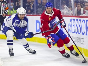 Louie Belpedio of Laval Rocket protects Frank Hora's puck of Syracuse Crunch during the first period of a playoff game at the Place Bell Sports Complex in Laval on Saturday, May 14, 2022.