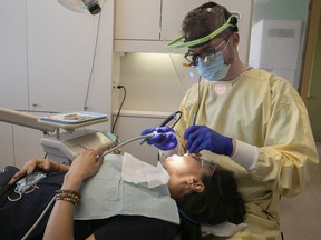 McGill University dental student Ziad Al Asmar, with patient Alix Johanna Canon Chavez at the Welcome Hall Mission’s Jim Lund Dental Clinic on Thursday May 12, 2022.