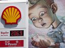A gas station sign is seen in front of a wall mural as gasoline prices top .00 per liter on Monday, May 9, 2022, in Montreal. 