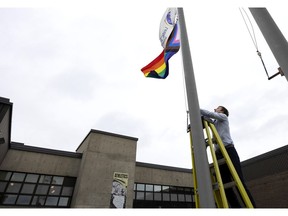 Principal Nick Hayter raises the Pride flag at Pierrefonds Community High School as part of International Day Against Homophobia, Transphobia and Biphobia. The school’s Genders and Sexualities Alliance hosted the ceremony on Tuesday.