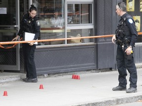 Montreal police officers investigate a stabbing near the Jarry métro station on Monday, May 23, 2022.