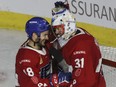 Rocket goalie Cayden Primeau and forward Danick Martel celebrate the team's Game 2 victory over the Rochester Americans at Place Bell in Laval on Monday.